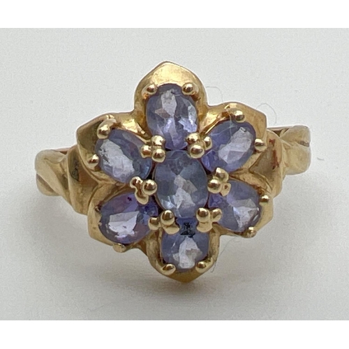 118 - A 9ct gold and tanzanite dress ring in a flower shaped setting of 7 oval cut stones. Stamped 9k insi... 