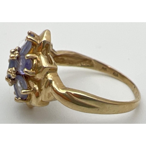 118 - A 9ct gold and tanzanite dress ring in a flower shaped setting of 7 oval cut stones. Stamped 9k insi... 