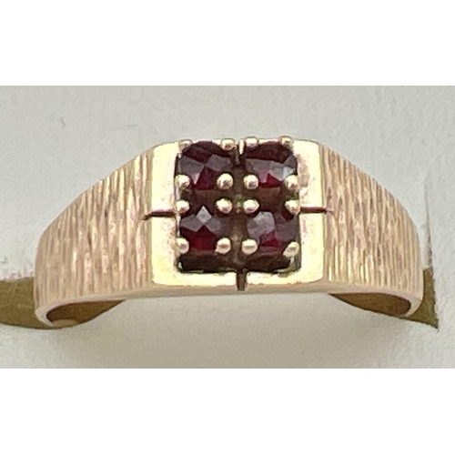 120 - A vintage 9ct gold and garnet ring set with 4 round cut stones in a square shaped setting. With bark... 