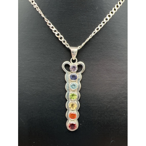 128 - A 925 silver pendant set with a rainbow of natural stones, on an 18