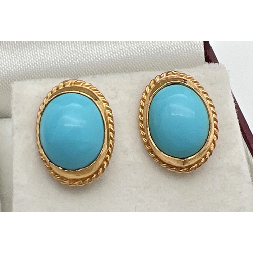 129 - A pair of turquoise and 9ct gold oval shaped stud earrings. Cabochons of turquoise set in an unmarke... 