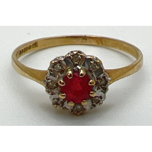 130 - A 9ct gold ruby and diamond ring in a halo style setting. Central round cut ruby surrounded by 8 ill... 