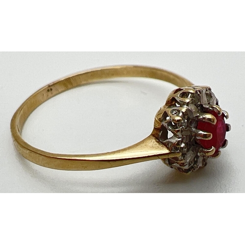 130 - A 9ct gold ruby and diamond ring in a halo style setting. Central round cut ruby surrounded by 8 ill... 