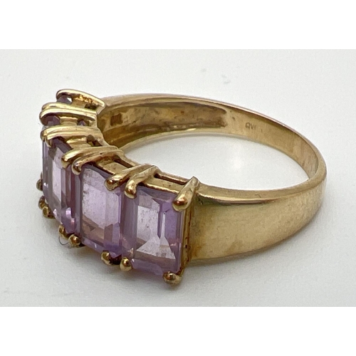 131 - A 9ct gold eternity style ring set with 5 large baguette cut amethyst stones. Each measuring approx.... 