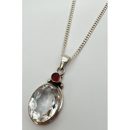 133 - A chunky silver, garnet and quartz pendant on an 18