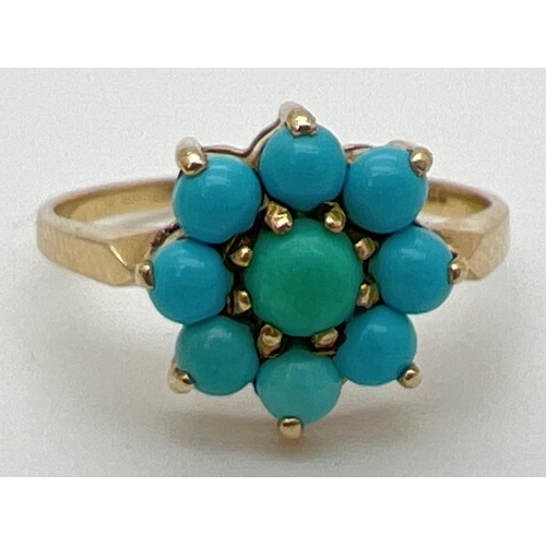 134 - A 9ct gold and turquoise dress ring with 9 cabochons in a flower shaped setting. Fully hallmarked in... 