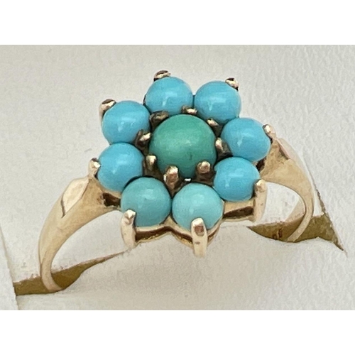 134 - A 9ct gold and turquoise dress ring with 9 cabochons in a flower shaped setting. Fully hallmarked in... 