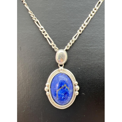 136 - A silver and lapis lazuli pendant on an 18