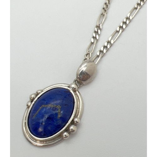 136 - A silver and lapis lazuli pendant on an 18