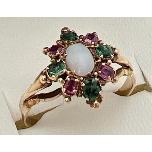 137 - A vintage yellow metal, opal, ruby and emerald ring, unmarked but tests as 9ct gold. Central oval op... 