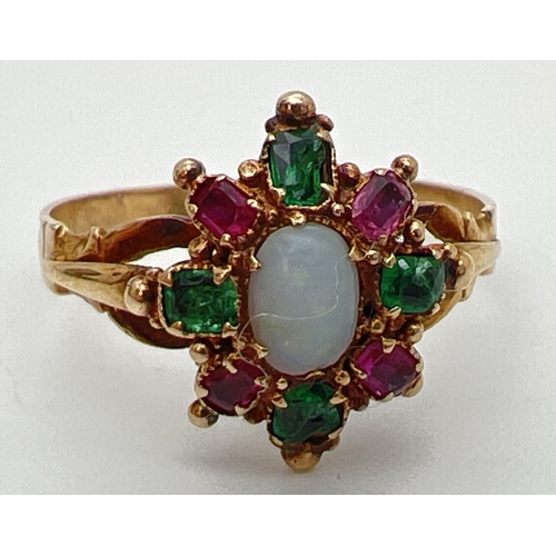 137 - A vintage yellow metal, opal, ruby and emerald ring, unmarked but tests as 9ct gold. Central oval op... 