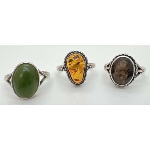 140 - 3 silver stone set rings; amber, jade and smoked quartz. amber ring unmarked, other 2 are stamped in... 