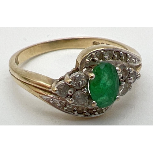 141 - A 9ct gold, emerald and diamond ring with a modern twist design setting. Central oval cut emerald wi... 