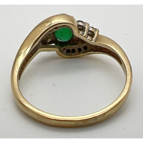 141 - A 9ct gold, emerald and diamond ring with a modern twist design setting. Central oval cut emerald wi... 