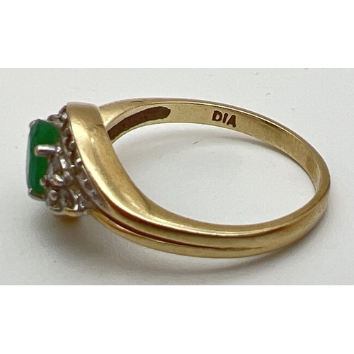 141 - A 9ct gold, emerald and diamond ring with a modern twist design setting. Central oval cut emerald wi... 