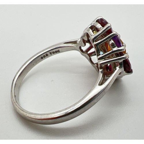 144 - A silver The Genuine Gem Company multi stone set ring, size N½. Central fire opal surrounded by garn... 