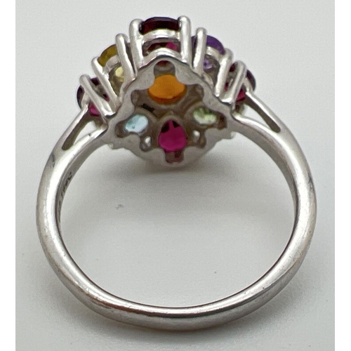 144 - A silver The Genuine Gem Company multi stone set ring, size N½. Central fire opal surrounded by garn... 