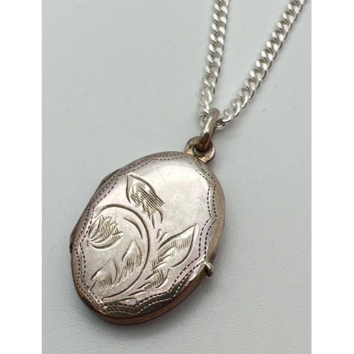 151 - A silver oval shaped locket on a 17