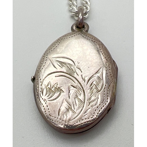 151 - A silver oval shaped locket on a 17