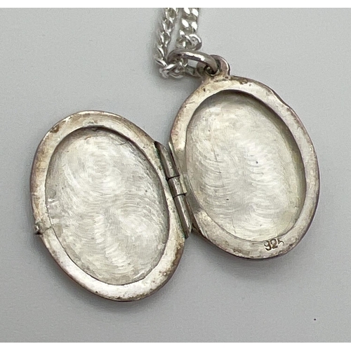 151 - A silver oval shaped locket on a 17