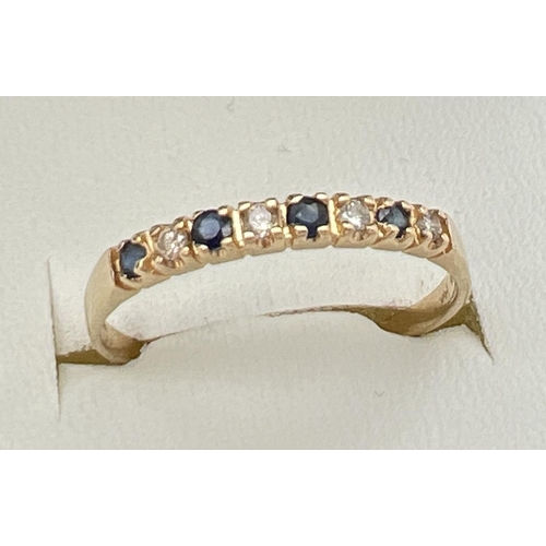 153 - A 14ct gold, diamond and sapphire eternity ring, size O. Set with alternating diamond and sapphire c... 