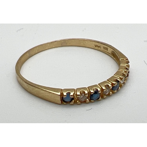 153 - A 14ct gold, diamond and sapphire eternity ring, size O. Set with alternating diamond and sapphire c... 