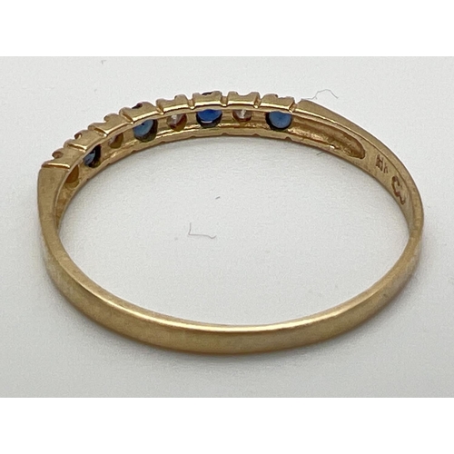 153 - A 14ct gold, diamond and sapphire eternity ring, size O. Set with alternating diamond and sapphire c... 