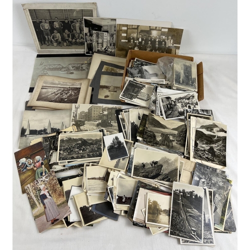 233 - A box of assorted Edwardian & vintage black & white photographs and postcards.