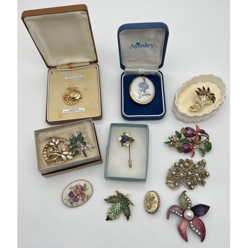 1011 - A collection of 12 vintage brooches in various styles, mostly floral, some stone set. To include exa... 