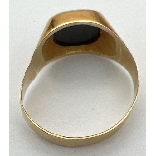 1029 - A men's 20ct gold and black onyx signet ring, band slightly misshapen. Stamped 83.5 inside band. Rin... 