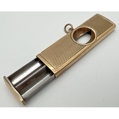 1133 - A vintage 9ct gold cigar cutter with engine turned decoration to both sides and central hanging bale... 