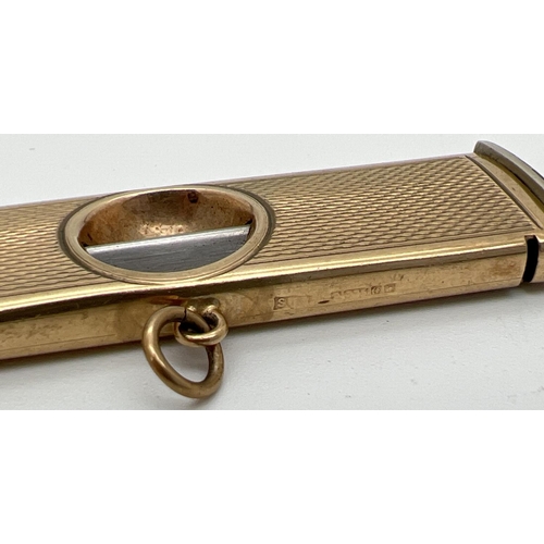 1133 - A vintage 9ct gold cigar cutter with engine turned decoration to both sides and central hanging bale... 