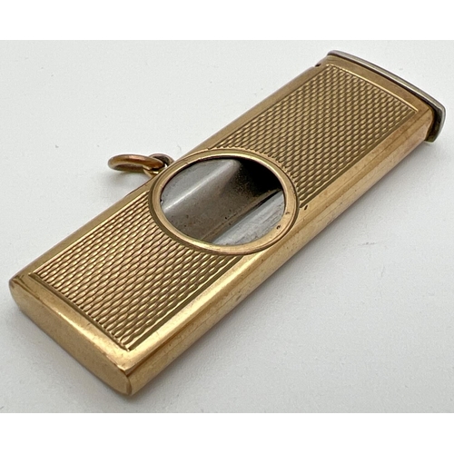 1133 - A vintage 9ct gold cigar cutter with engine turned decoration to both sides and central hanging bale... 