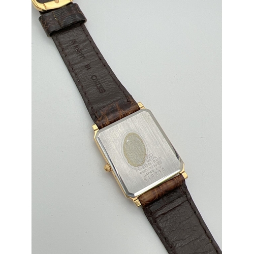 1119 - A vintage square shaped Seiko (9020-5730) gold tone cased watch with original brown leather strap. W... 