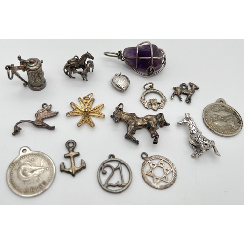 1034 - 15 silver and white metal charms/pendants in varying conditions. To include beer stein, giraffe, cla... 