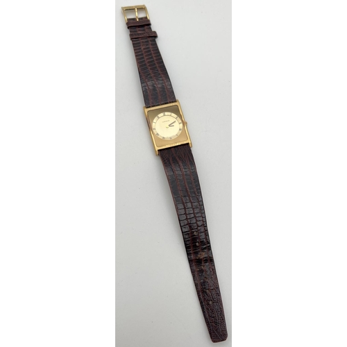 A vintage Catena Swiss quartz square shaped gold tone watch, with