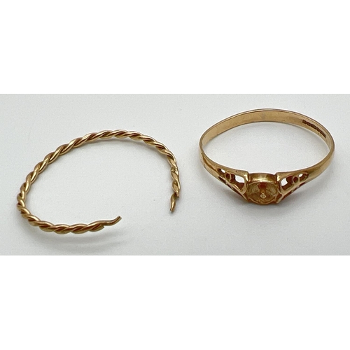 1040 - 2 scrap gold rings. A thin twist design band (cut through) tests as 9ct gold. Together with misshape... 