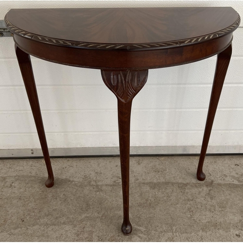 1335 - A vintage mahogany half circular, 3 legged hall table by the Northampton Cabinet Co Ltd. With carved... 