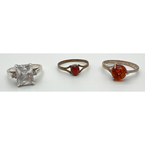 1042 - 3 silver stone set rings. A cocktail ring set with a large square cut clear stone and a small round ... 