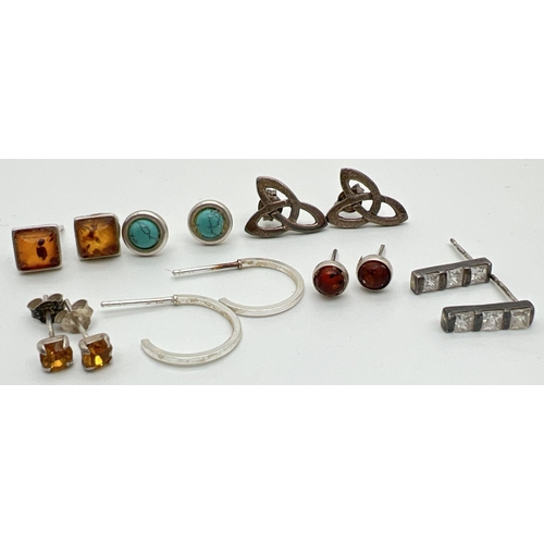 1043 - 7 pairs of silver and white metal stud and hoop style earrings in varying designs, some with butterf... 