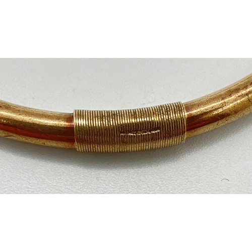 1045 - A vintage 9ct gold bangle with engraved floral pattern. Bangle has been repaired and strengthened wi... 