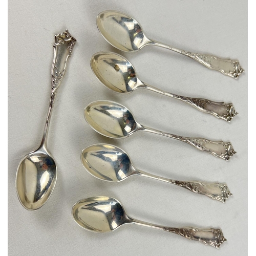 1137 - A set of 6 Edwardian silver teaspoons with ornately shaped handles and decorative embossed design. E... 