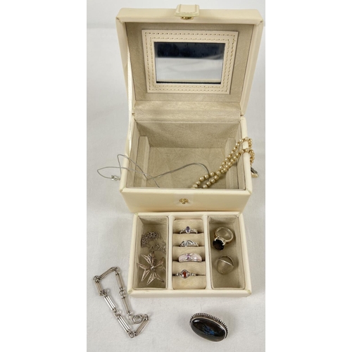 1057 - A small modern cream faux leather jewellery box with lift out tray containing a collection of silver... 