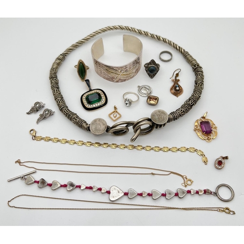 1051 - A small collection of costume jewellery. To include a large ethnic design torque style necklace, a d... 