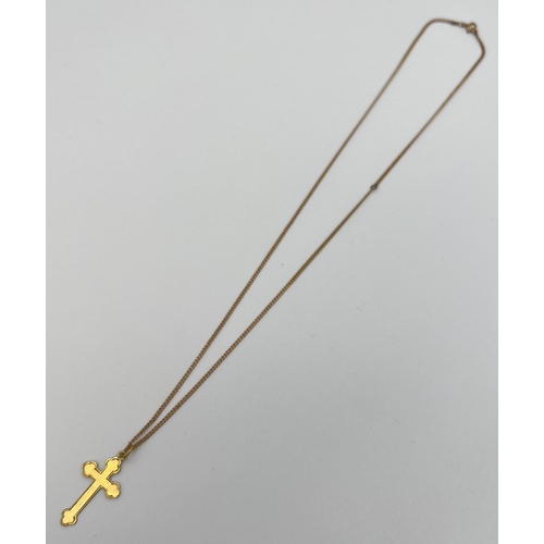 1062 - A vintage 9ct gold cross pendant on an 18