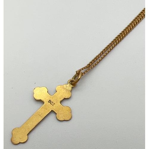 1062 - A vintage 9ct gold cross pendant on an 18