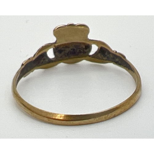 1064 - A 9ct gold Claddagh ring. Size Q, approx 1g. Hallmarked inside band.