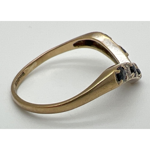 1068 - A vintage 9ct gold wishbone ring set with alternating diamonds & sapphires. Fully hallmarked inside ... 