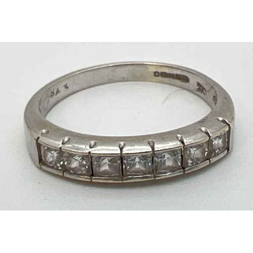 1086 - A 9ct white gold half eternity ring, channel set with 7 square cut cubic zirconia stones. Gold  mark... 