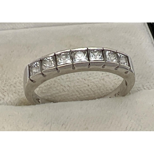 1086 - A 9ct white gold half eternity ring, channel set with 7 square cut cubic zirconia stones. Gold  mark... 